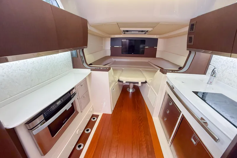 Slide: The Image of Luxurious interior of 2022 Grady-White Canyon 456 boat with modern kitchen and seating area. - 29