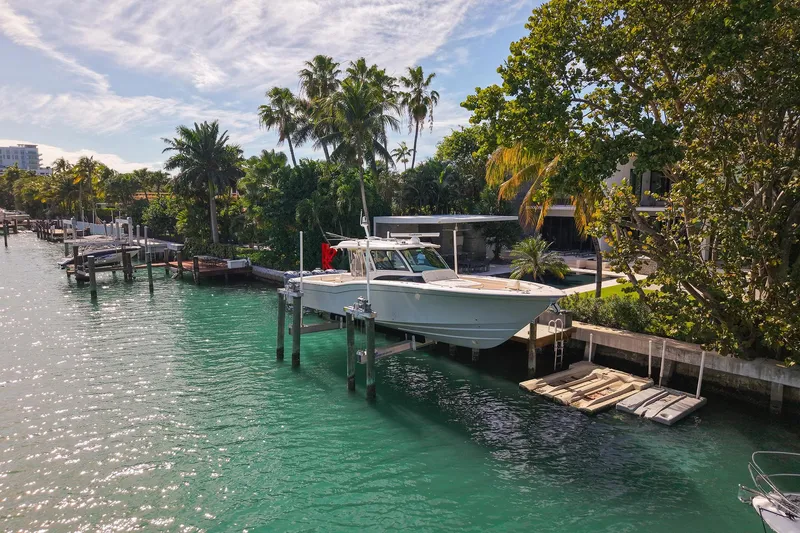 Slide: The Image of 2022 Grady-White Canyon 456 boat interior with luxurious seating and waterfront view. - 36