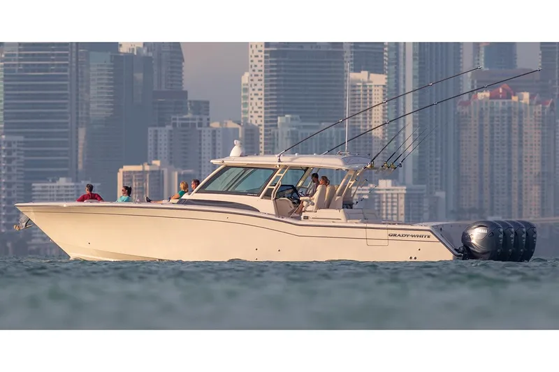 Slide: The Image of 2022 Grady-White Canyon 456 boat on clear blue water with city skyline in background. - 4