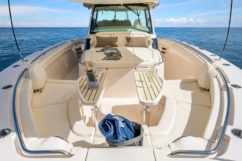 Slide: The Image of 2022 Grady-White Canyon 456 boat on calm water near luxury waterfront homes. - 6