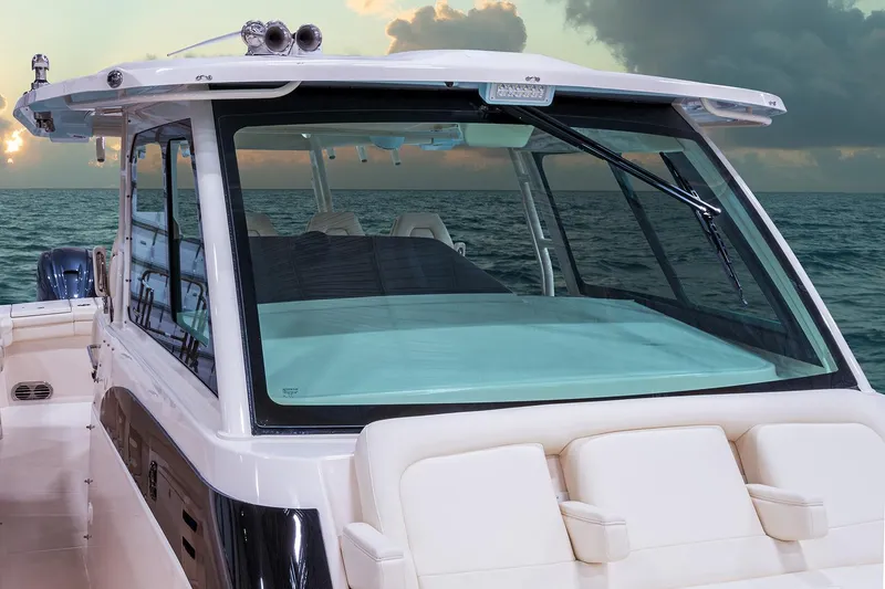 Slide: The Image of 2022 Grady-White Canyon 456 boat docked by tropical waterfront home. - 8