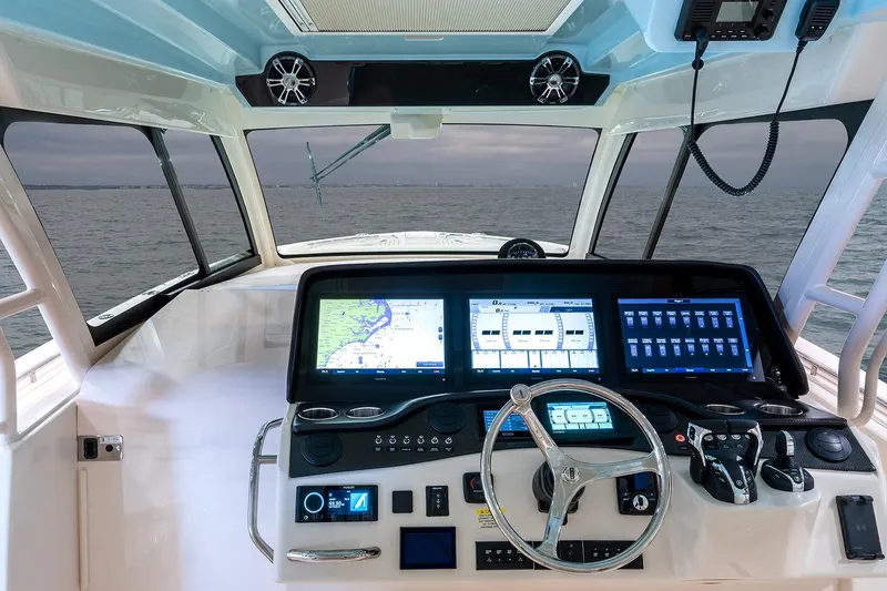 Slide: The Image of 2022 Grady-White Canyon 456 boat docked, city skyline in background, clear blue sky. - 9