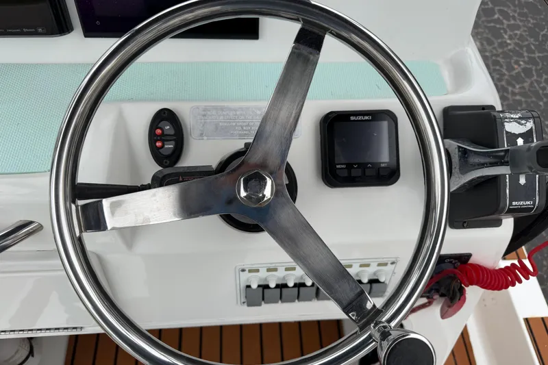 Slide: The Image of Steering wheel and controls of 2017 Shallow Sport 24 Sport boat. - 12