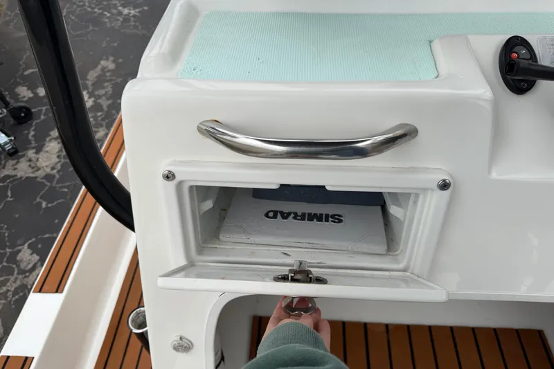 Slide: The Image of 2017 Shallow Sport 24 Sport boat console with storage compartment and handle. - 15