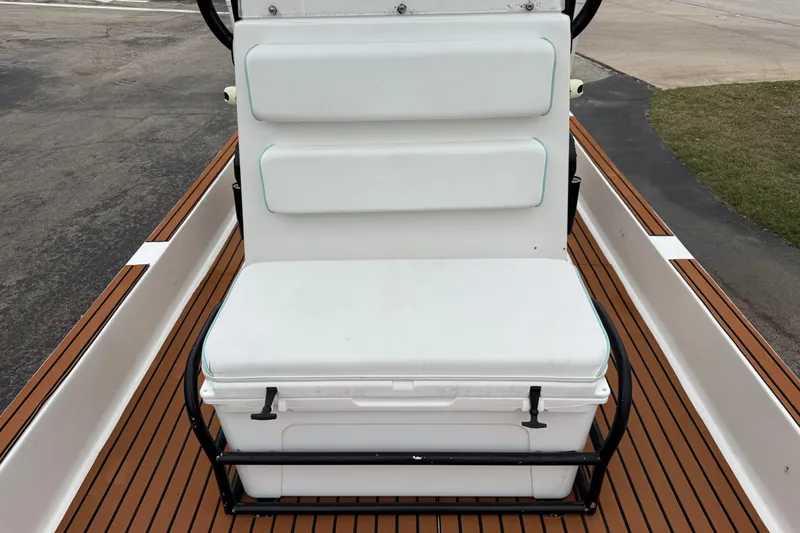 Slide: The Image of 2017 Shallow Sport 24 Sport boat with cushioned seating and wooden deck. - 17