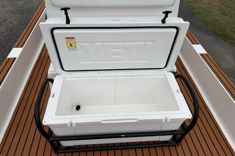 Slide: The Image of Open YETI cooler on 2017 Shallow Sport 24 Sport boat deck. - 18