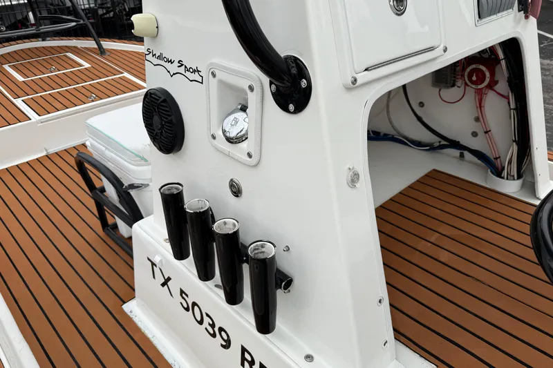 Slide: The Image of 2017 Shallow Sport 24 Sport boat interior with rod holders and teak flooring. - 19
