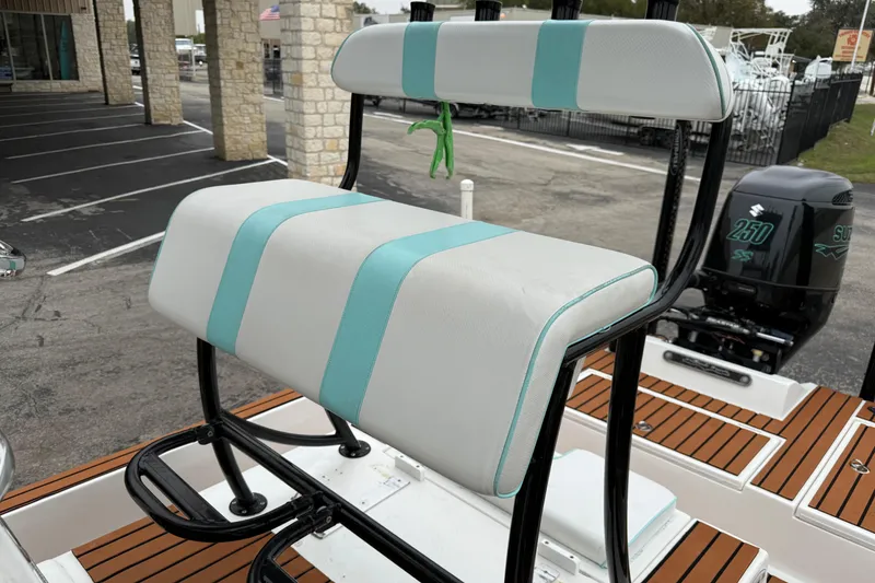 Slide: The Image of 2017 Shallow Sport 24 Sport boat seat with teal accents and Suzuki 250 engine. - 22