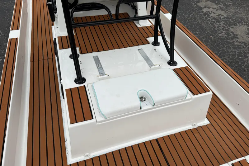 Slide: The Image of 2017 Shallow Sport 24 Sport boat deck with wood-like flooring and seating area. - 23