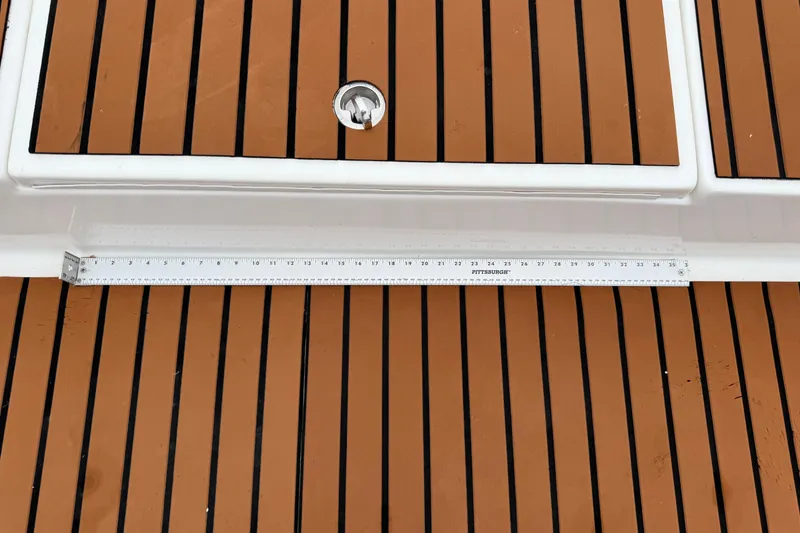 Slide: The Image of 2017 Shallow Sport 24 Sport boat deck with wood finish and measuring ruler. - 31