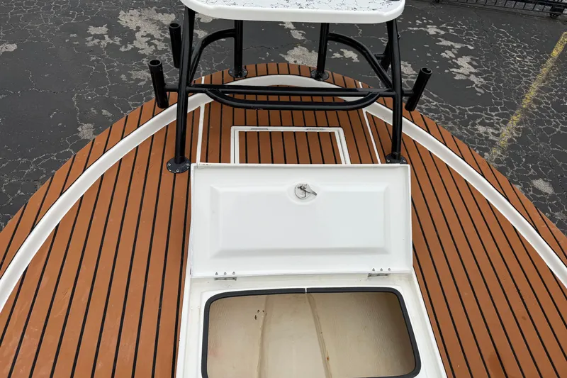 Slide: The Image of 2017 Shallow Sport 24 Sport boat deck with open hatch and fishing rod holders. - 32