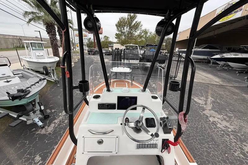 Slide: The Image of 2017 Shallow Sport 24 Sport boat interior with steering wheel and control panel. - 9