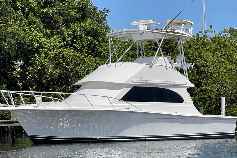 The Image of 2003 Egg Harbor 37 Sport Fisher boat docked on calm water under blue sky. - 0