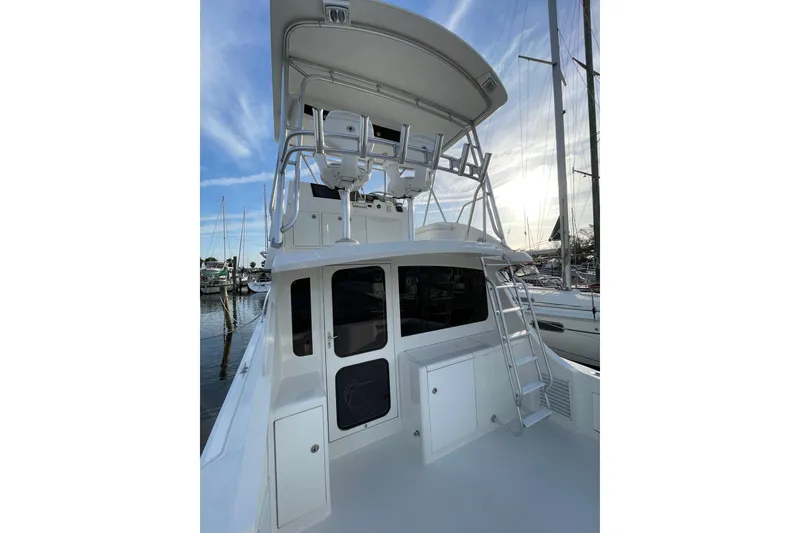 Slide: The Image of 2003 Egg Harbor 37 Sport Fisher boat with upper deck and ladder in marina. - 10