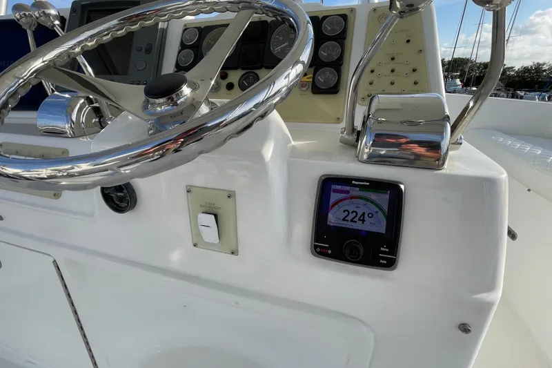 Slide: The Image of Control panel of 2003 Egg Harbor 37 Sport Fisher with steering wheel and navigation display. - 12