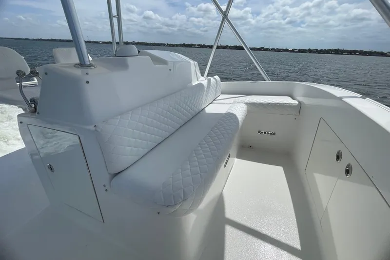 Slide: The Image of 2003 Egg Harbor 37 Sport Fisher boat interior with white seating and ocean view. - 13