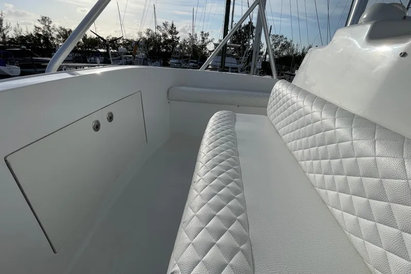 Slide: The Image of 2003 Egg Harbor 37 Sport Fisher boat with white quilted seating and storage compartment. - 14