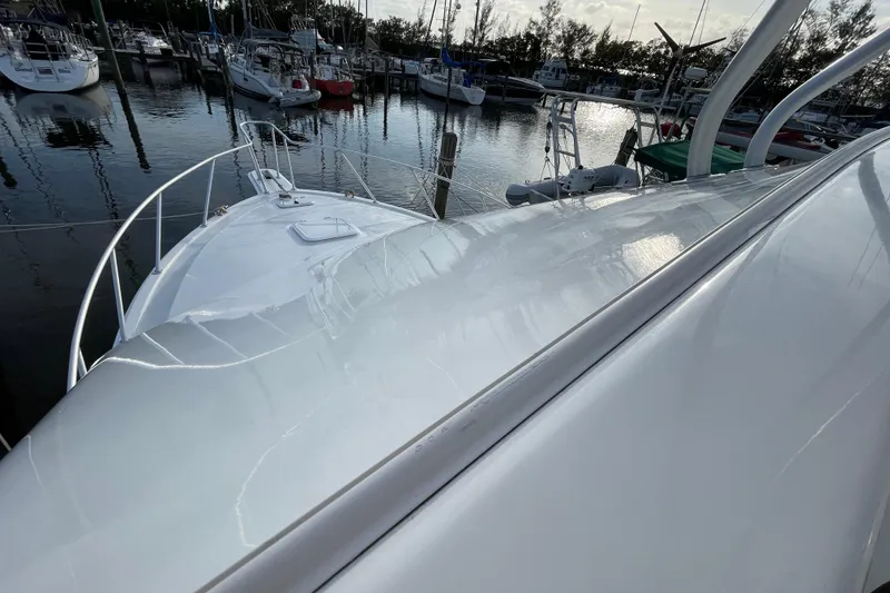 Slide: The Image of 2003 Egg Harbor 37 Sport Fisher yacht docked in a marina, reflecting sunlight. - 17