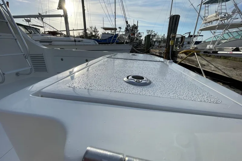 Slide: The Image of 2003 Egg Harbor 37 Sport Fisher boat docked, showcasing sleek deck design and marina background. - 20