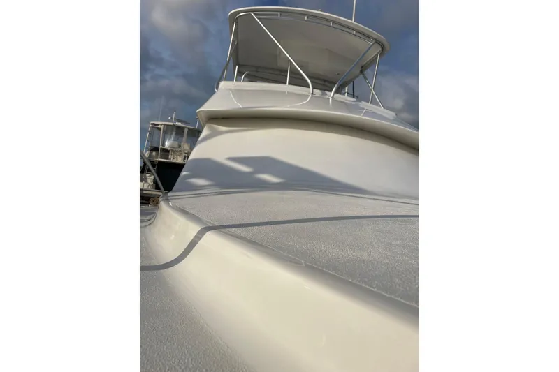 Slide: The Image of 2003 Egg Harbor 37 Sport Fisher boat with sleek design under cloudy sky. - 26