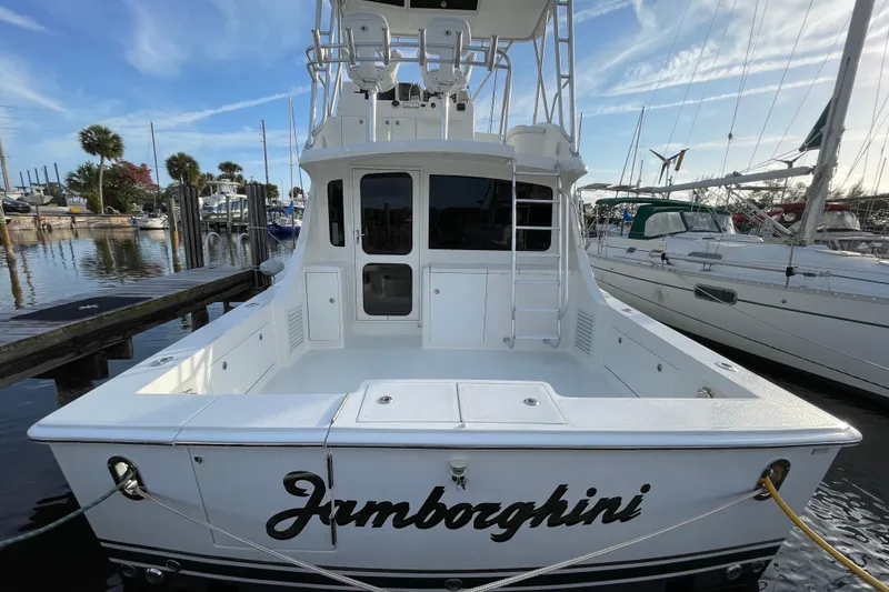 Slide: The Image of 2003 Egg Harbor 37 Sport Fisher docked at marina, rear view with clear sky. - 3