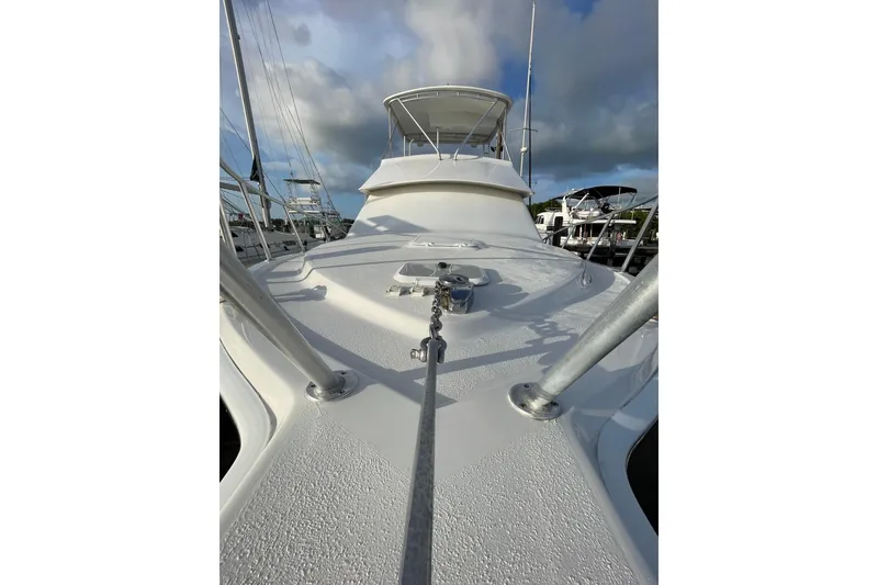 Slide: The Image of 2003 Egg Harbor 37 Sport Fisher yacht deck with clear sky and marina view. - 32