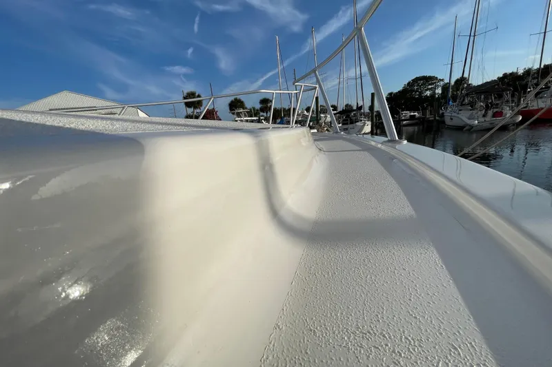 Slide: The Image of 2003 Egg Harbor 37 Sport Fisher boat deck with marina background under blue sky. - 33