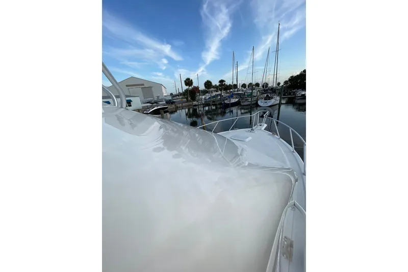 Slide: The Image of 2003 Egg Harbor 37 Sport Fisher docked at marina under blue sky. - 38
