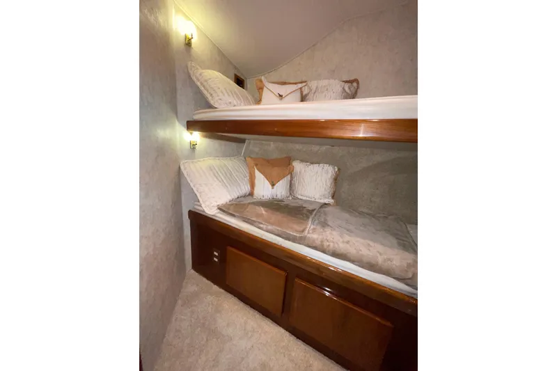 Slide: The Image of 2003 Egg Harbor 37 Sport Fisher cabin with cozy bunk beds and soft lighting. - 48