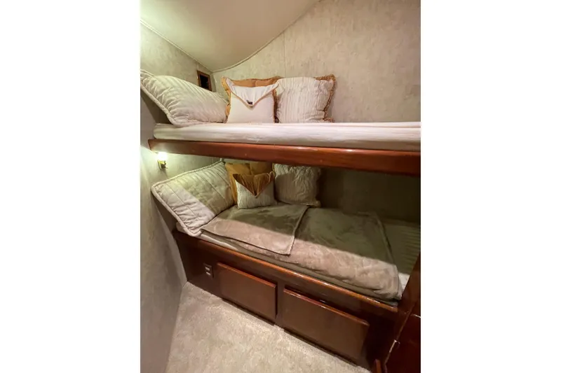 Slide: The Image of Interior of 2003 Egg Harbor 37 Sport Fisher with cozy bunk beds and plush pillows. - 49