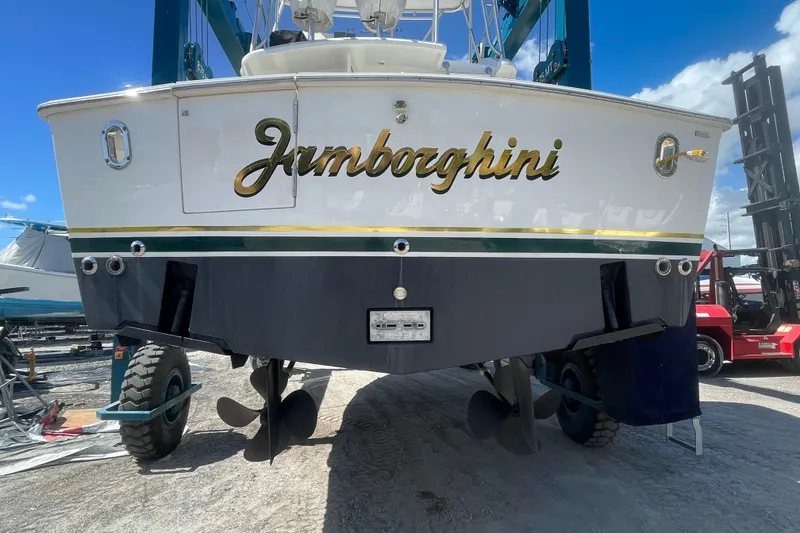 Slide: The Image of 2003 Egg Harbor 37 Sport Fisher boat named "Jamborghini" on dry dock with visible propellers. - 5