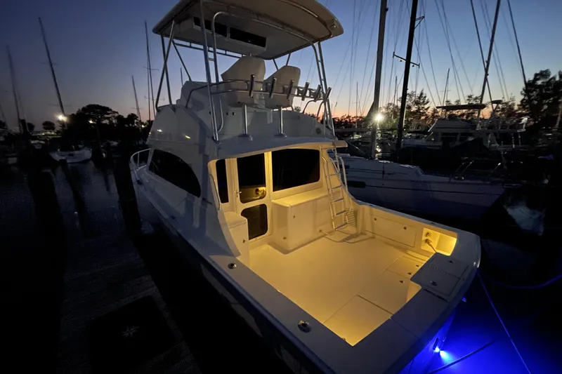 Slide: The Image of 2003 Egg Harbor 37 Sport Fisher yacht illuminated at dusk in marina. - 51