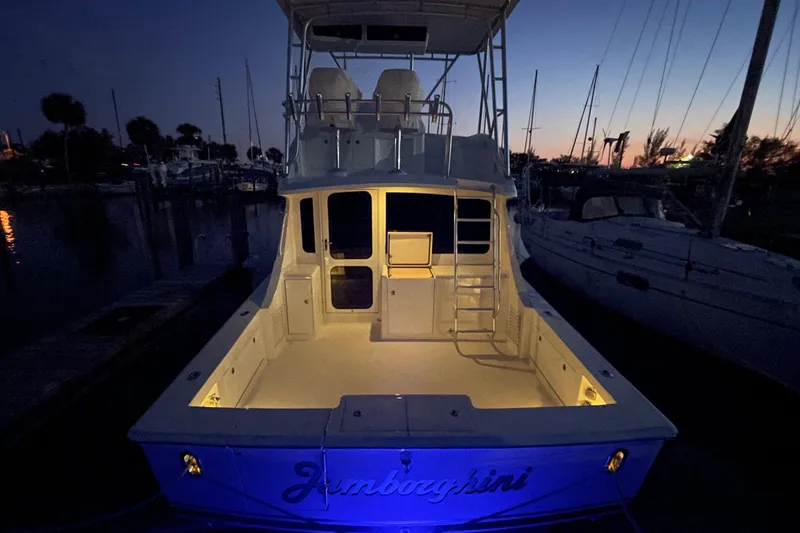 Slide: The Image of 2003 Egg Harbor 37 Sport Fisher boat illuminated at dusk in a marina setting. - 52