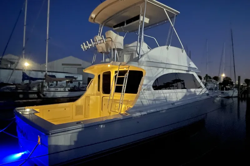 Slide: The Image of 2003 Egg Harbor 37 Sport Fisher yacht illuminated at night in a marina setting. - 53