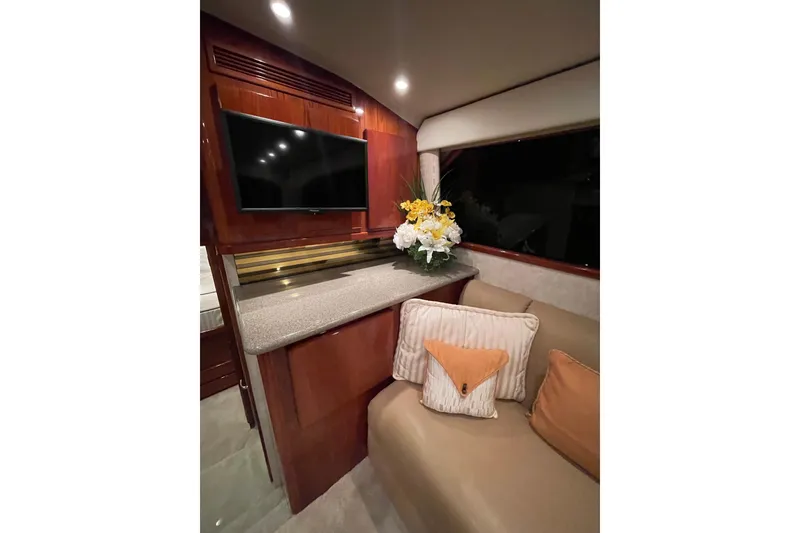 Slide: The Image of Luxurious interior of 2003 Egg Harbor 37 Sport Fisher with TV, flowers, and cushions. - 56