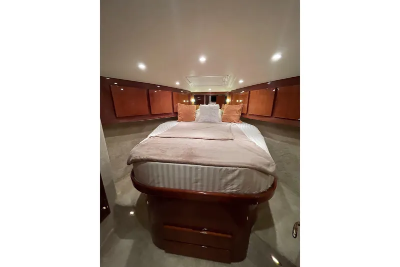Slide: The Image of Luxurious cabin interior of 2003 Egg Harbor 37 Sport Fisher with cozy bedding and wood accents. - 61