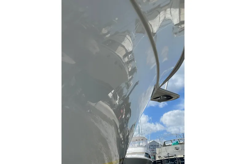 Slide: The Image of 2003 Egg Harbor 37 Sport Fisher boat with reflective hull, docked under blue sky. - 7