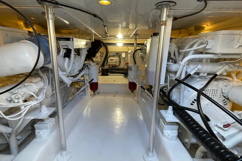 Slide: The Image of Engine room of 2003 Egg Harbor 37 Sport Fisher, showcasing clean, organized machinery. - 70