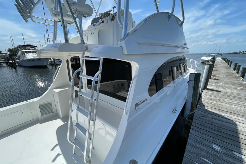 Slide: The Image of 2003 Egg Harbor 37 Sport Fisher docked, showcasing sleek design and ladder access. - 9
