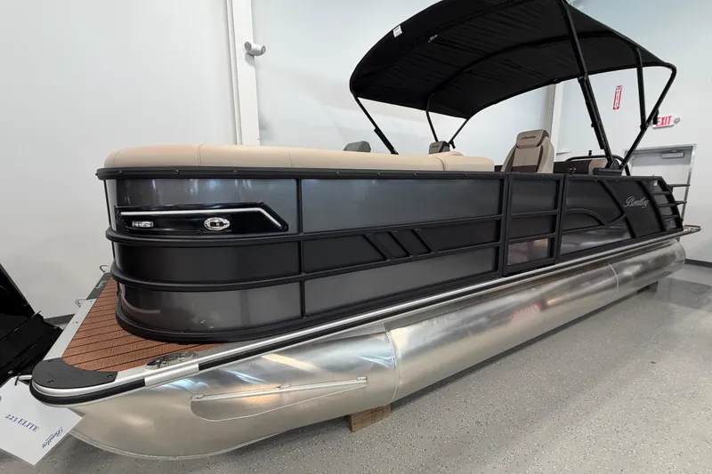 Slide: The Image of 2026 Bentley Pontoons Elite 223 Swingback, sleek design, black canopy, luxury pontoon boat. - 1