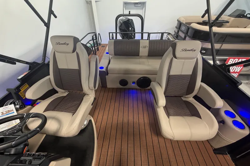 Slide: The Image of 2026 Bentley Pontoons Elite 223 Swingback interior with luxurious seating and ambient lighting. - 12