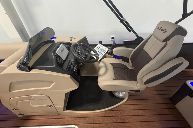 Slide: The Image of 2026 Bentley Pontoons Elite 223 Swingback helm with luxurious captain's chair and modern controls. - 13