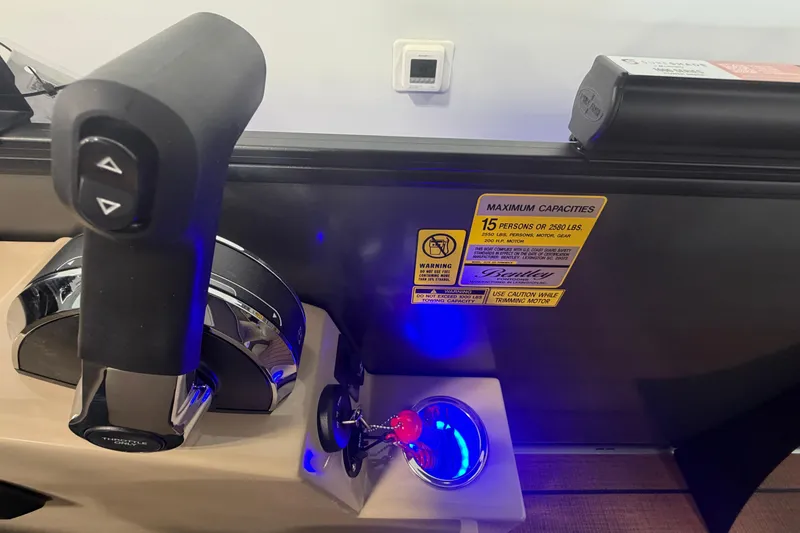 Slide: The Image of Control panel of 2026 Bentley Pontoons Elite 223 Swingback with capacity warning label. - 14