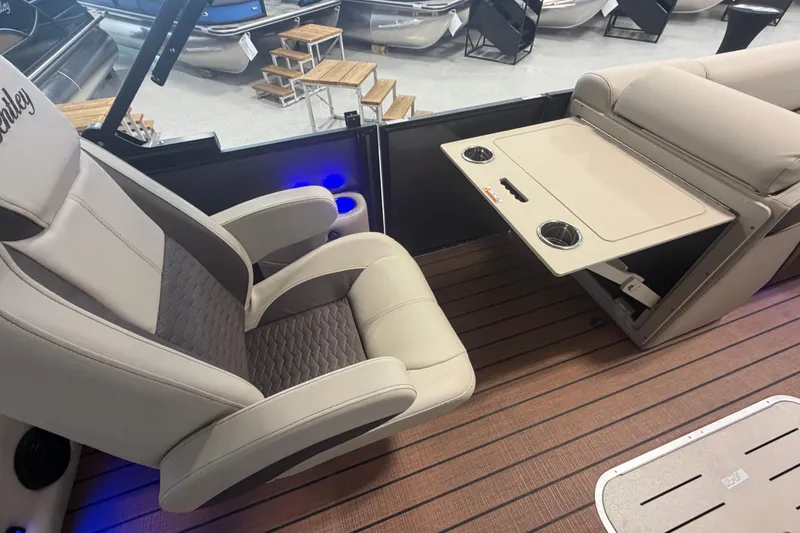 Slide: The Image of 2026 Bentley Pontoons Elite 223 Swingback interior with luxurious seating and foldable table. - 17