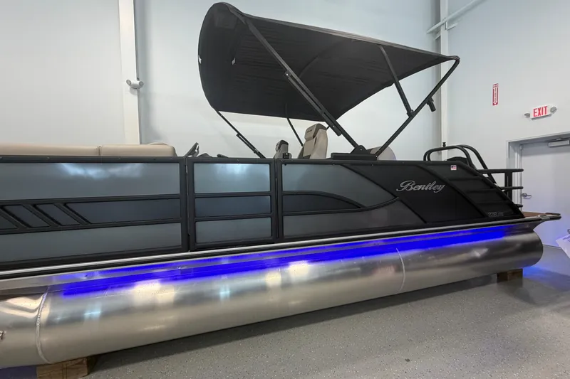 Slide: The Image of 2026 Bentley Pontoons Elite 223 Swingback with sleek design and blue underglow lighting. - 5