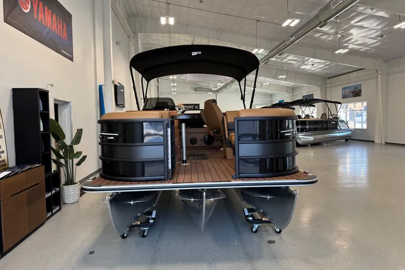 Slide: The Image of 2026 Bentley Pontoons Elite 223 Swingback in showroom, featuring sleek design and luxury seating. - 3
