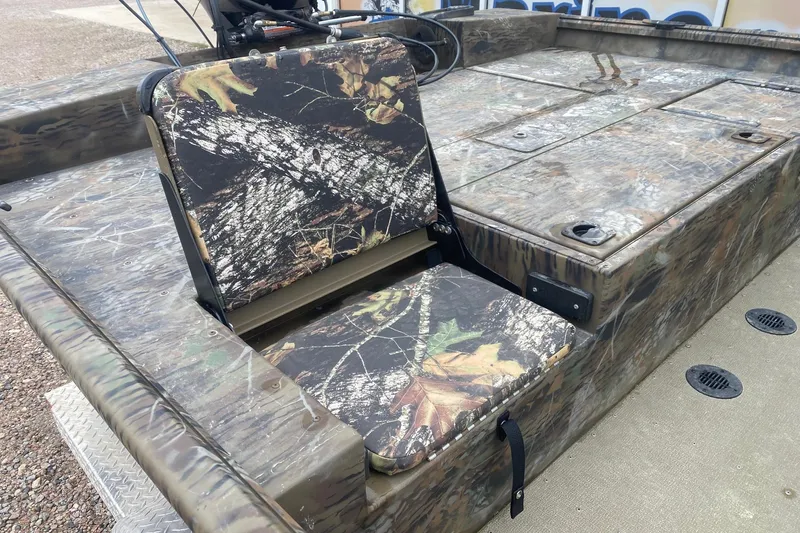 Slide: The Image of 2025 G3 Gator Tough 20 CCJ boat with camouflage seating and storage compartments. - 8