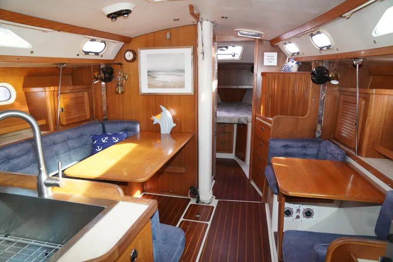 Slide: The Image of Interior of 2000 Catalina 36 MkII sailboat with cozy seating and wooden finishes. - 23