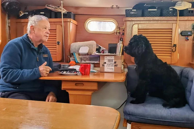 Slide: The Image of Man and dog sitting inside a 2000 Catalina 36 MkII sailboat cabin. - 26