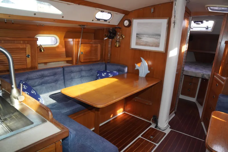 Slide: The Image of Interior of 2000 Catalina 36 MkII sailboat with cozy seating and wooden finishes. - 29